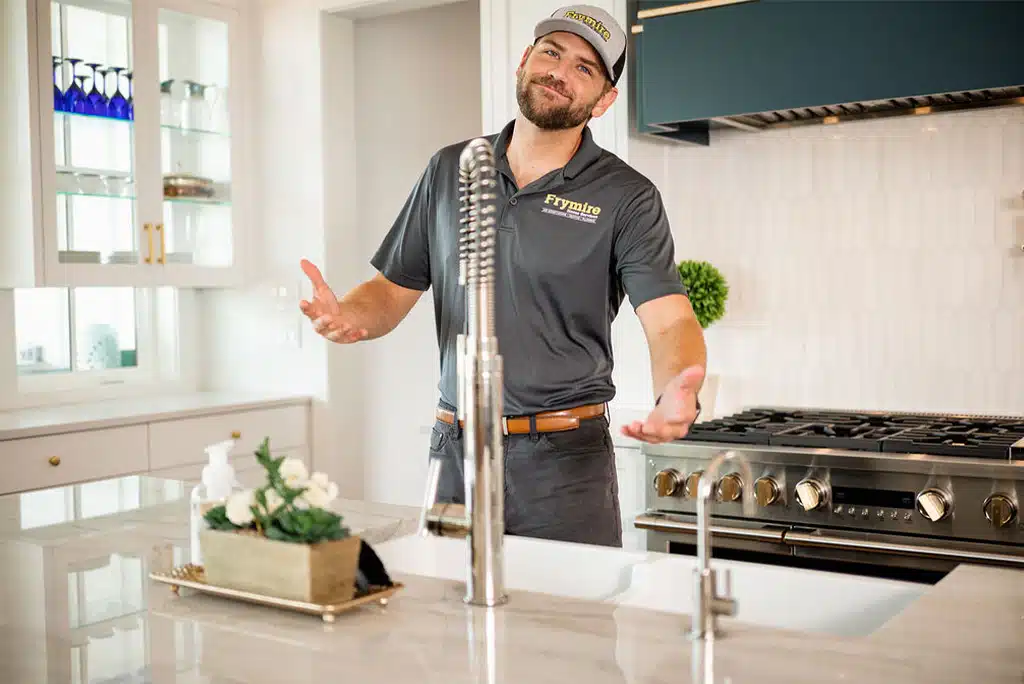  a man standing in a kitchen 