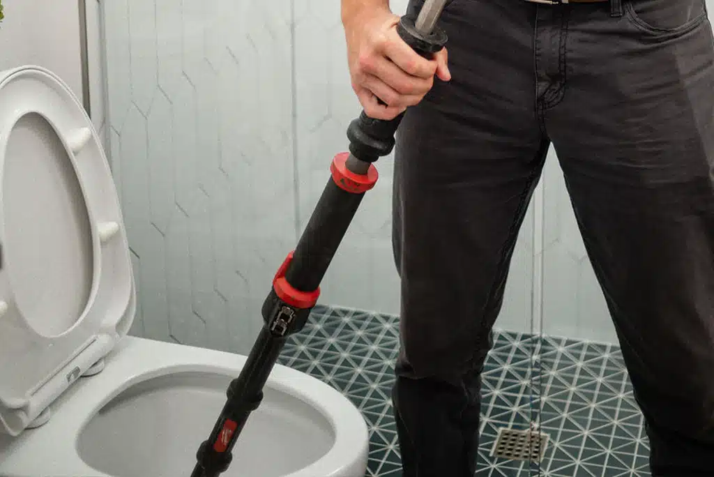 Frymire Home Services technician completing toilet repair services in a home 