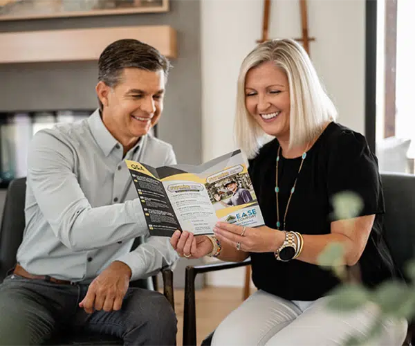  Texas homeowners holding a Frymire brochure 